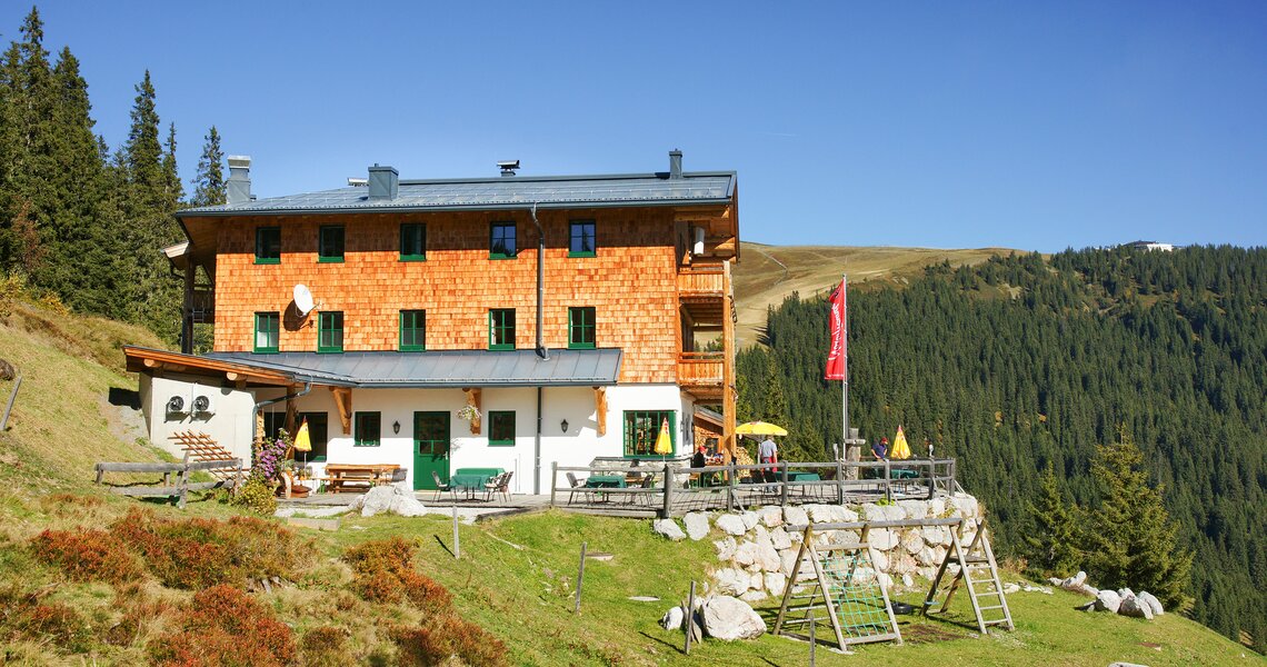 Traditional mountain hut with a terrace and playground surrounded by nature. | © Holiday Region National Park Hohe Tauern
