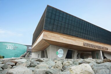  National Park Center with modern wood and concrete architecture and "360°" building in the background. | © Harry Liebmann